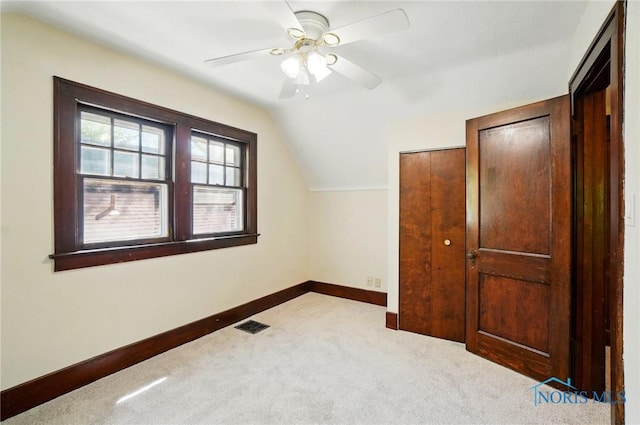 additional living space featuring baseboards, carpet floors, vaulted ceiling, and ceiling fan