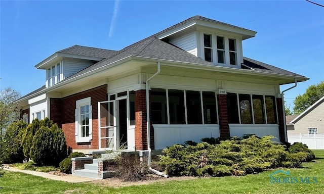 5907 N Berkey Southern Rd, Berkey, OH 43504 - bungalow-style home featuring brick siding, a sunroom, and roof with shingles