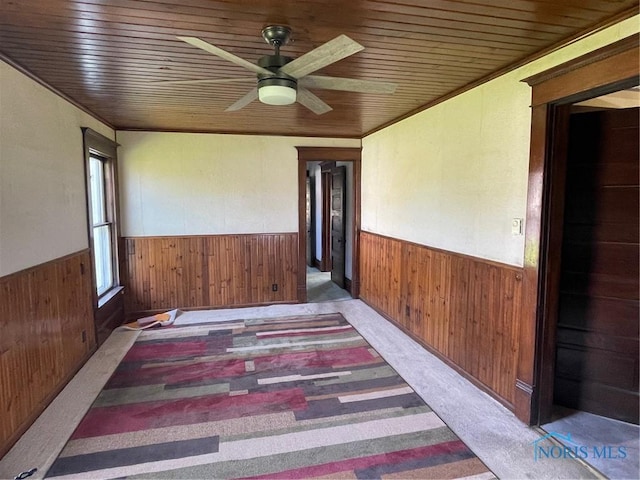 5907 N Berkey Southern Rd, Berkey, OH 43504 - carpeted empty room with a wainscoted wall, wooden walls, ceiling fan, and wooden ceiling
