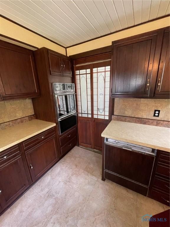 5907 N Berkey Southern Rd, Berkey, OH 43504 - kitchen with oven, tasteful backsplash, light countertops, a warming drawer, and dark brown cabinets