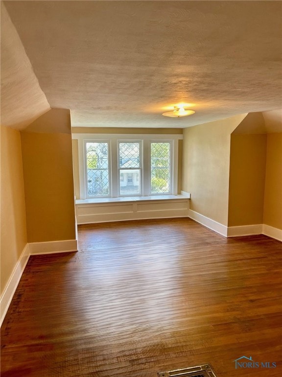 5907 N Berkey Southern Rd, Berkey, OH 43504 - bonus room featuring wood finished floors, baseboards, plenty of natural light, a textured ceiling, and lofted ceiling