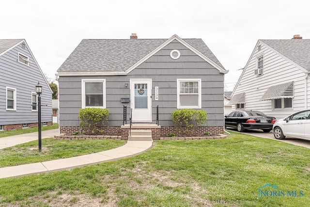 3134 Cragmoor Ave, Toledo, OH 43614 - view of front facade featuring a shingled roof, a front yard, and a chimney