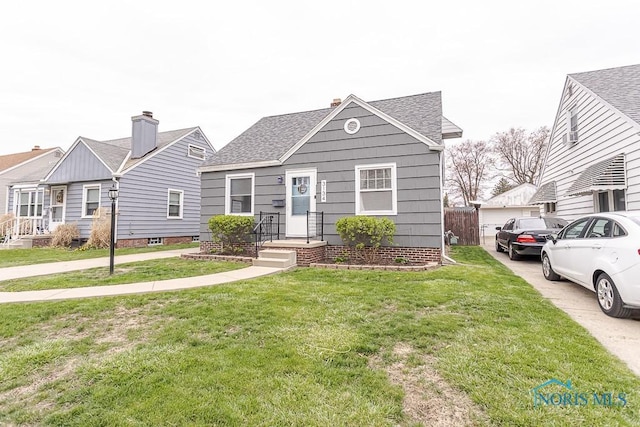 3134 Cragmoor Ave, Toledo, OH 43614 - view of front of home with a shingled roof and a front lawn