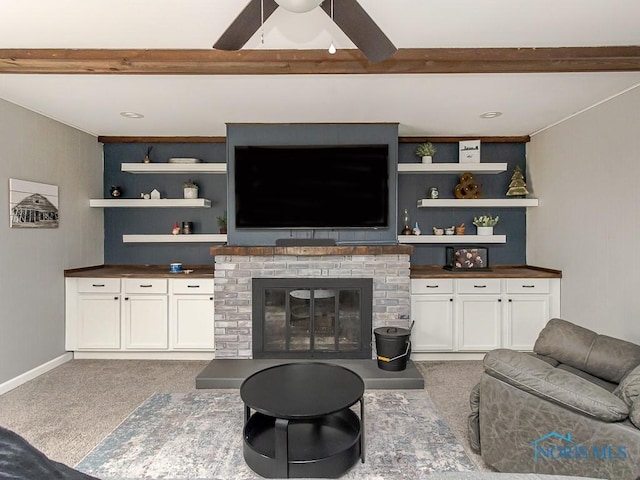 3134 Cragmoor Ave, Toledo, OH 43614 - carpeted living area featuring beamed ceiling, a ceiling fan, a brick fireplace, and baseboards