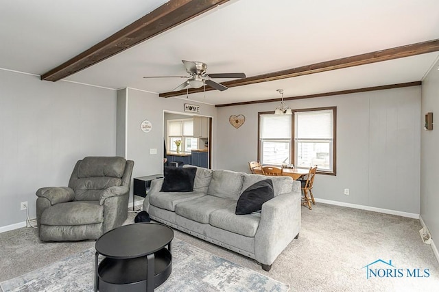 3134 Cragmoor Ave, Toledo, OH 43614 - living area featuring beamed ceiling, plenty of natural light, ceiling fan, light carpet, and baseboards