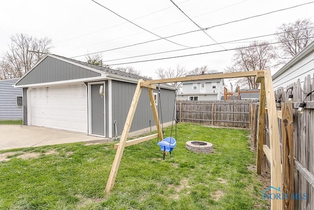 3134 Cragmoor Ave, Toledo, OH 43614 - view of yard featuring a fire pit, a garage, and an outdoor structure