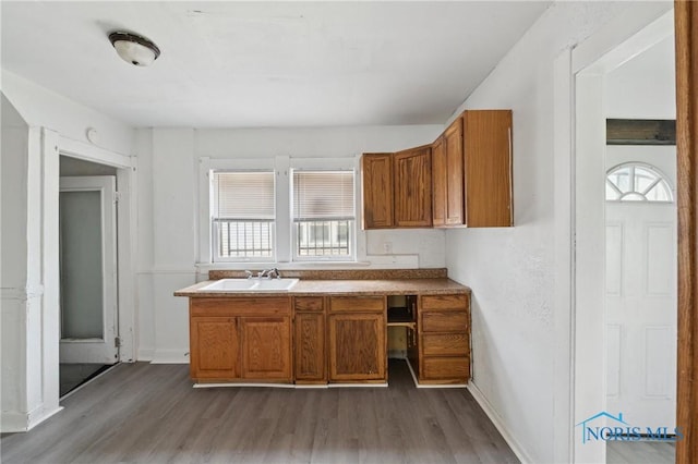 1908 Parkdale Ave, Toledo, OH 43607 - kitchen with a sink, dark wood finished floors, brown cabinetry, and baseboards