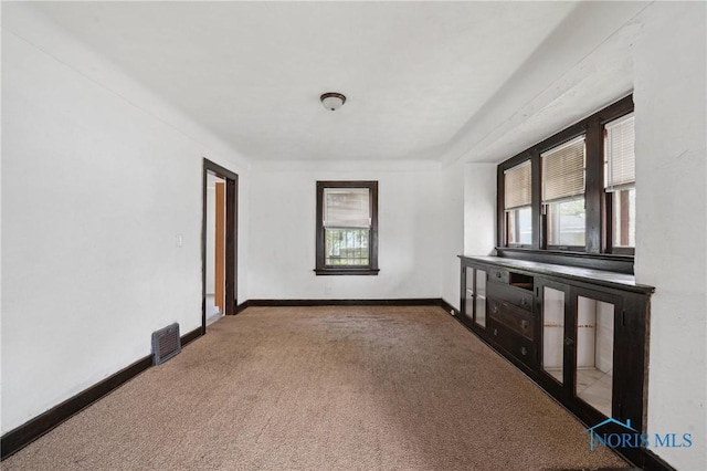 1908 Parkdale Ave, Toledo, OH 43607 - unfurnished living room featuring carpet floors and baseboards