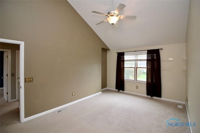 unfurnished room with light colored carpet, ceiling fan, baseboards, and high vaulted ceiling