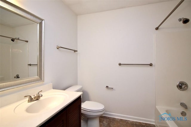 bathroom featuring toilet, vanity, washtub / shower combination, and baseboards