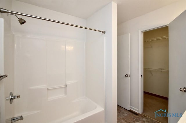 bathroom featuring shower / bathtub combination and a spacious closet