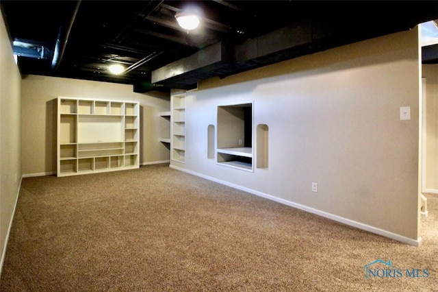 finished below grade area with carpet flooring, baseboards, and built in shelves