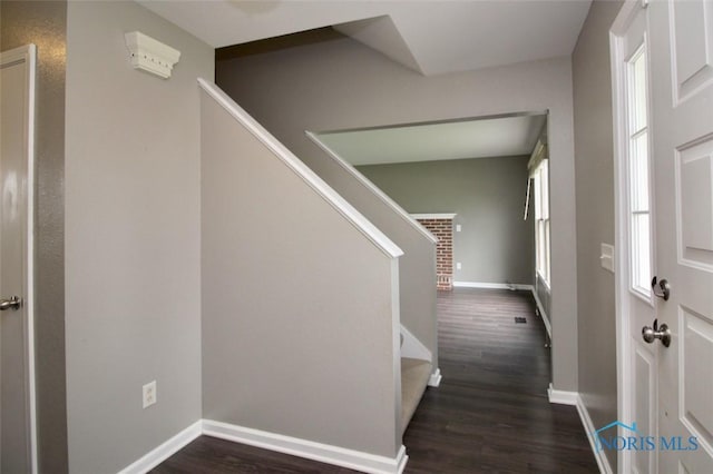 stairway featuring wood finished floors and baseboards