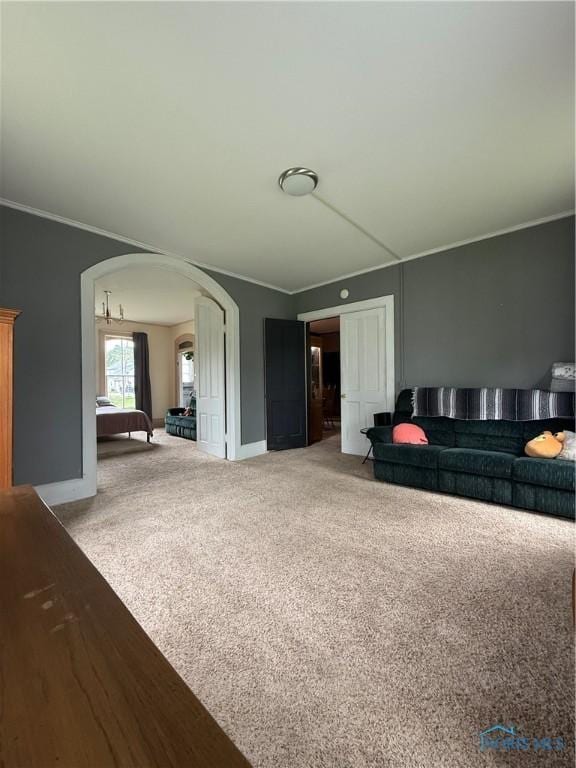 318 S Main St, North Baltimore, OH 45872 - living area featuring arched walkways, carpet, ornamental molding, and baseboards