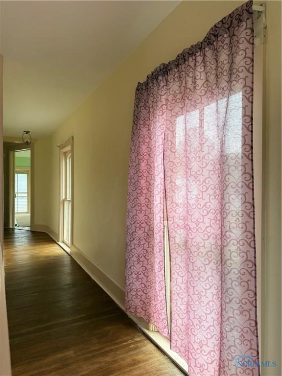 318 S Main St, North Baltimore, OH 45872 - hallway with dark wood-style flooring and baseboards