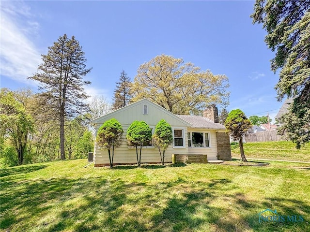 624 Myers St, Toledo, OH 43609 - back of property with a chimney and board and batten siding