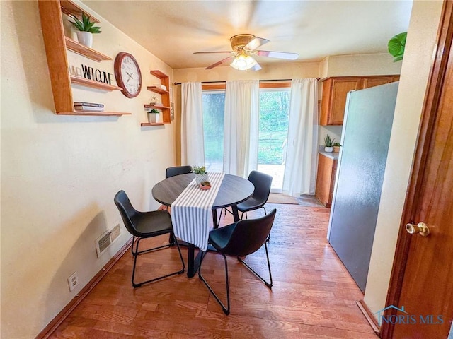 624 Myers St, Toledo, OH 43609 - dining room featuring ceiling fan and light wood-style floors