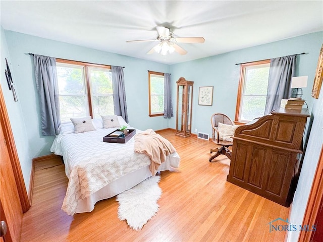 624 Myers St, Toledo, OH 43609 - bedroom with multiple windows, light wood-style flooring, and baseboards