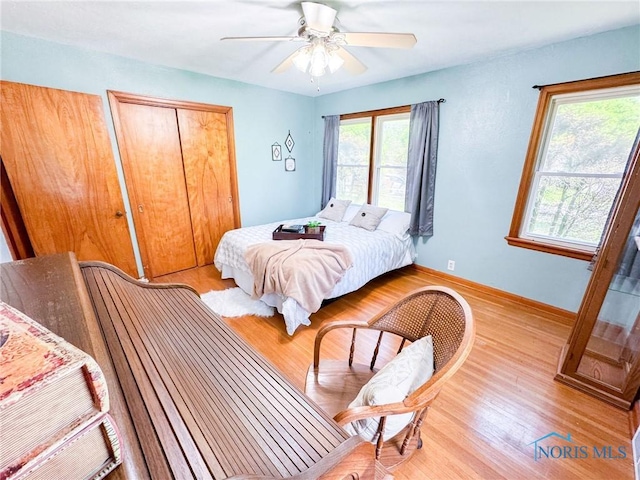624 Myers St, Toledo, OH 43609 - bedroom featuring light wood finished floors, a closet, a ceiling fan, and baseboards