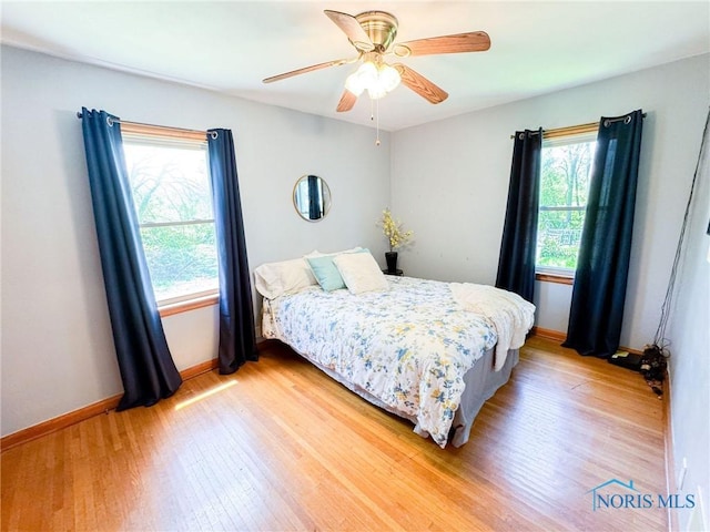 624 Myers St, Toledo, OH 43609 - bedroom with multiple windows, light wood finished floors, and baseboards