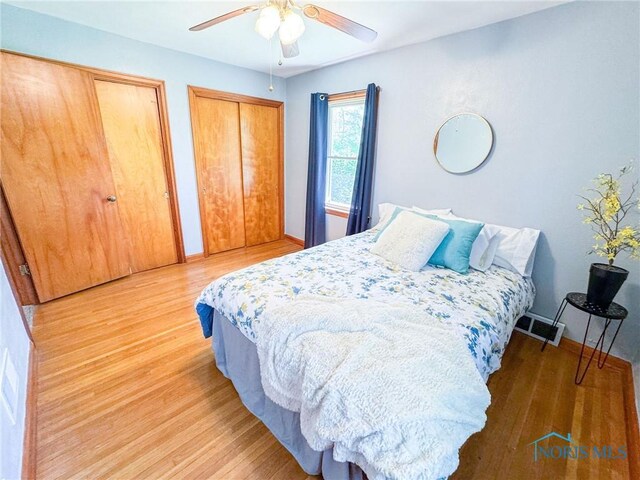 624 Myers St, Toledo, OH 43609 - bedroom featuring two closets, light wood-style flooring, a ceiling fan, and baseboards