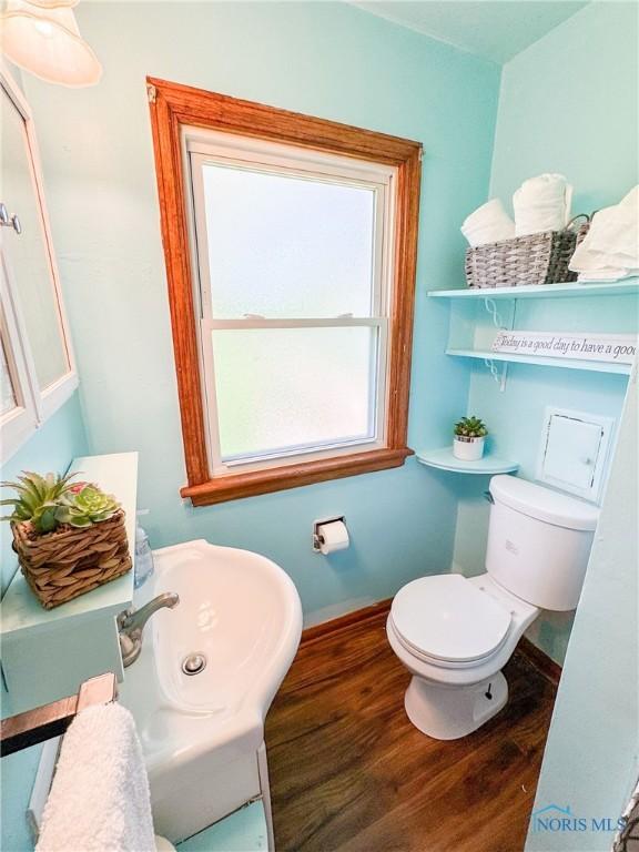 624 Myers St, Toledo, OH 43609 - half bath with wood finished floors, toilet, and baseboards