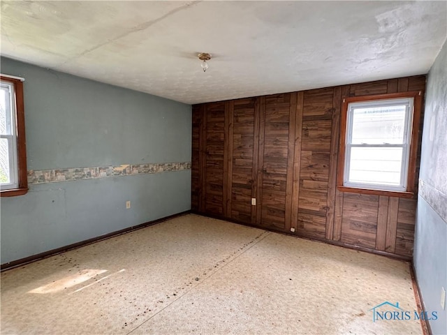 unfurnished bedroom with wooden walls