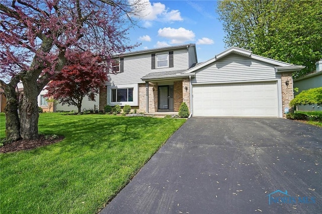 5532 Bentwood Dr, Toledo, OH 43615 - traditional-style home with driveway, a garage, brick siding, and a front lawn