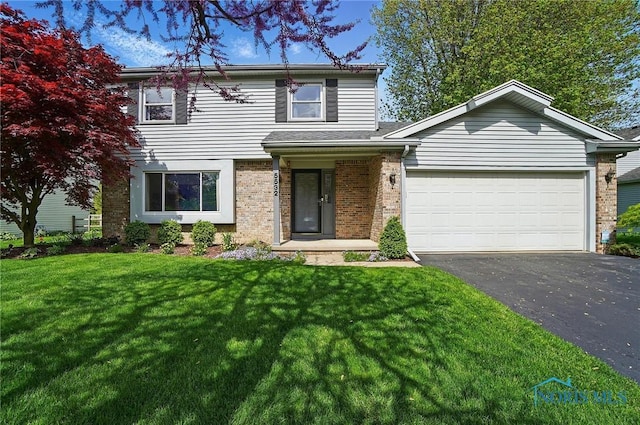 5532 Bentwood Dr, Toledo, OH 43615 - traditional home featuring driveway, brick siding, a front yard, and an attached garage