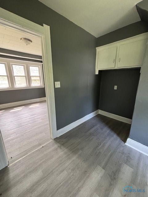 938 Western Ave, Toledo, OH 43609 - unfurnished dining area featuring dark wood-style floors and baseboards