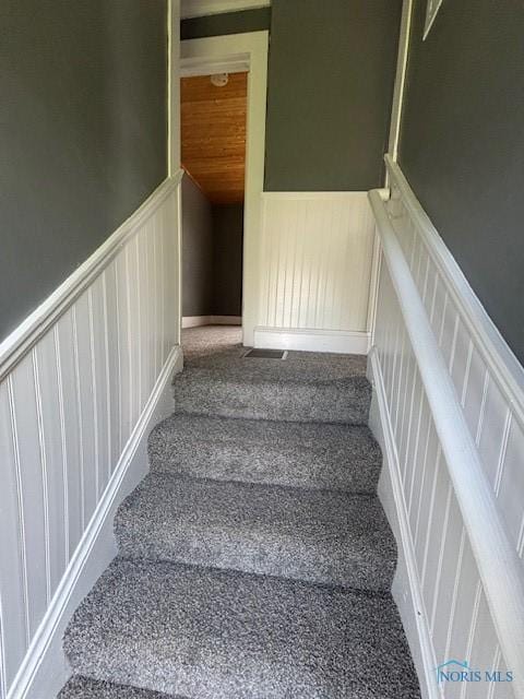 938 Western Ave, Toledo, OH 43609 - stairs with wainscoting, a decorative wall, and carpet flooring