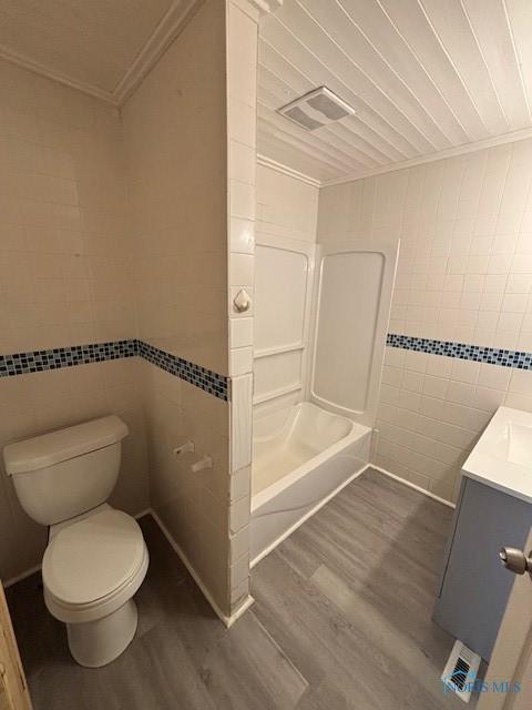 938 Western Ave, Toledo, OH 43609 - bathroom with tile walls, wood finished floors, ornamental molding, vanity, and toilet