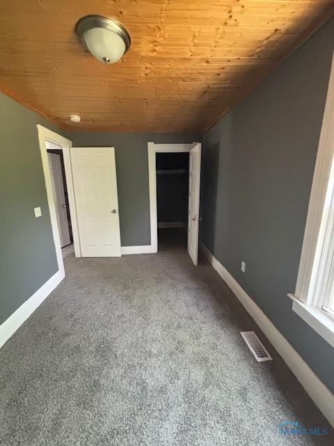 938 Western Ave, Toledo, OH 43609 - unfurnished bedroom with wooden ceiling, carpet flooring, baseboards, and a closet
