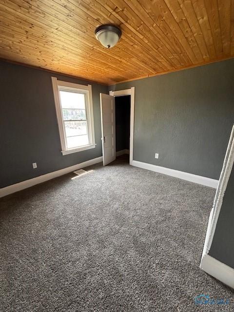 938 Western Ave, Toledo, OH 43609 - unfurnished room with wood ceiling, baseboards, and carpet flooring
