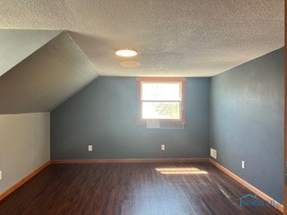 64 Saint Clair St, Tiffin, OH 44883 - bonus room featuring wood finished floors, a textured ceiling, vaulted ceiling, and baseboards