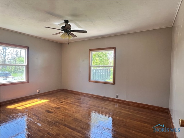 64 Saint Clair St, Tiffin, OH 44883 - empty room with hardwood / wood-style flooring, a ceiling fan, and baseboards