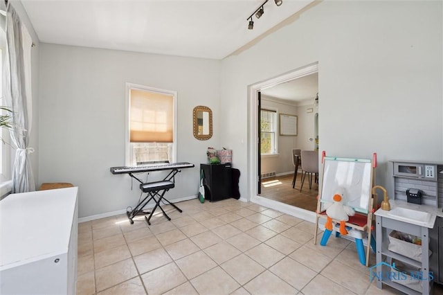 interior space featuring light tile patterned floors and baseboards