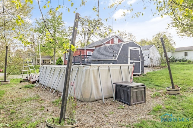 1037 Stevenson St, Napoleon, OH 43545 - back of property with a gambrel roof, a storage shed, a yard, and an outbuilding