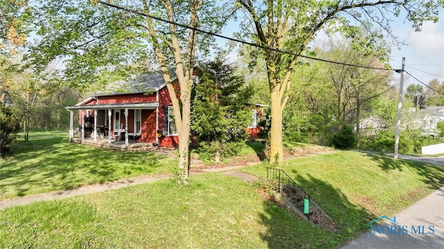 1037 Stevenson St, Napoleon, OH 43545 - view of grassy yard featuring covered porch