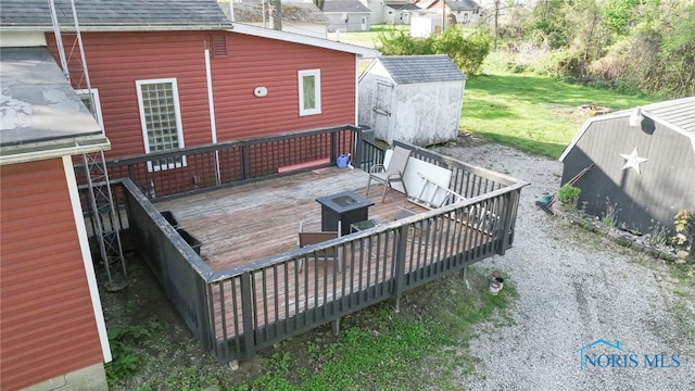 1037 Stevenson St, Napoleon, OH 43545 - wooden terrace featuring a storage shed and an outbuilding