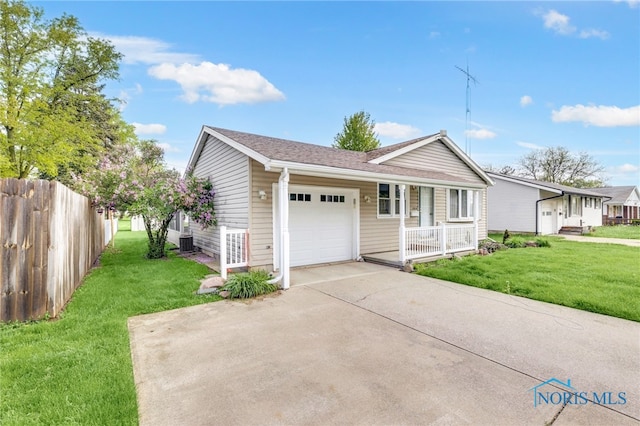 588 Douglas Dr, Wauseon, OH 43567 - view of front of house featuring a garage, a porch, driveway, and a shingled roof