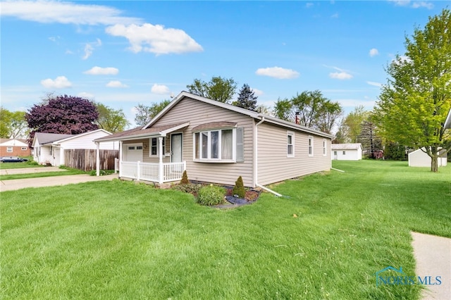 588 Douglas Dr, Wauseon, OH 43567 - view of front of property featuring concrete driveway, an attached garage, and a front yard