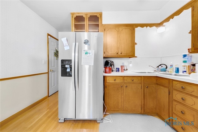 588 Douglas Dr, Wauseon, OH 43567 - kitchen with stainless steel fridge, light wood-type flooring, light countertops, a sink, and brown cabinets