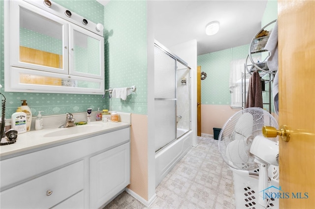 588 Douglas Dr, Wauseon, OH 43567 - full bathroom featuring wallpapered walls, bath / shower combo with glass door, and vanity