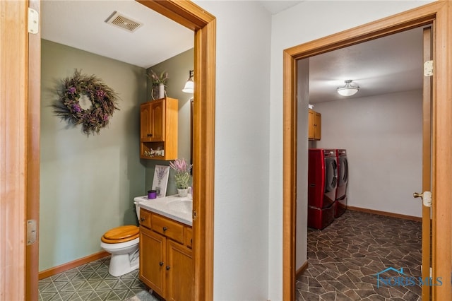 9704 Monto Ln, Findlay, OH 45840 - bathroom featuring independent washer and dryer, toilet, vanity, and baseboards