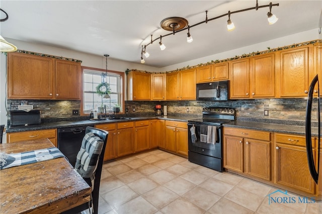 9704 Monto Ln, Findlay, OH 45840 - kitchen with black appliances, brown cabinetry, a sink, tasteful backsplash, and dark countertops