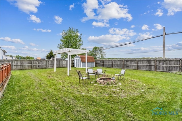 9704 Monto Ln, Findlay, OH 45840 - view of yard featuring a shed, a fire pit, and an outdoor structure