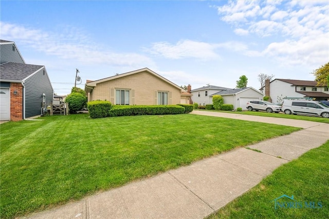 2659 Coveview Dr, Toledo, OH 43611 - view of front facade featuring a front lawn and brick siding