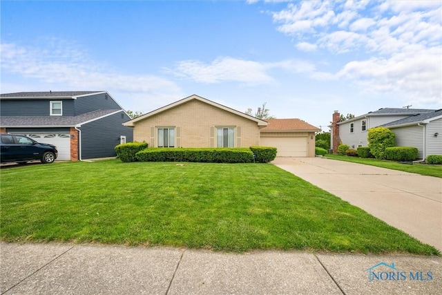 2659 Coveview Dr, Toledo, OH 43611 - view of front of home with brick siding, concrete driveway, a front lawn, and a garage