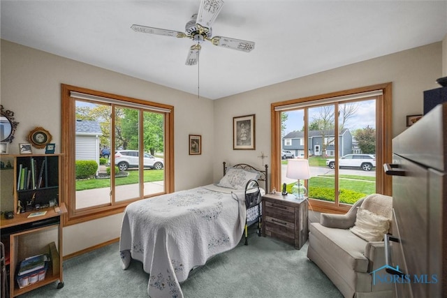 2659 Coveview Dr, Toledo, OH 43611 - bedroom with multiple windows, carpet floors, stainless steel refrigerator, and a ceiling fan